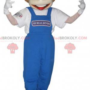 Jungenmaskottchen in blauen Overalls gekleidet - Redbrokoly.com