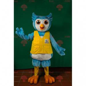 Blauwe en witte uil mascotte met een geel vest - Redbrokoly.com