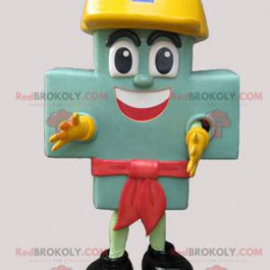 Mascota de la cruz verde gigante con un casco amarillo -