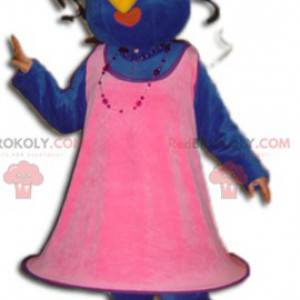 Mascotte uccello blu e giallo vestito con un abito rosa -