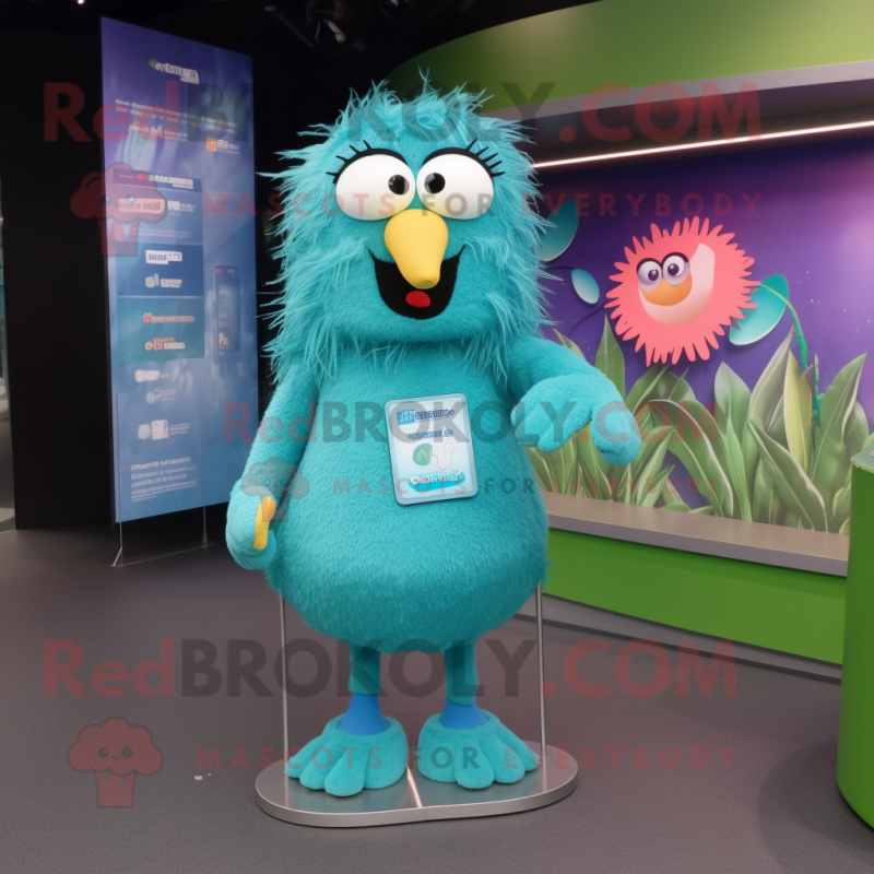 Turquoise Kiwi mascot costume character dressed with a Sweatshirt and Hairpins Turquoise Kiwi mascot costume character dressed with a Sweatshirt and Hairpins