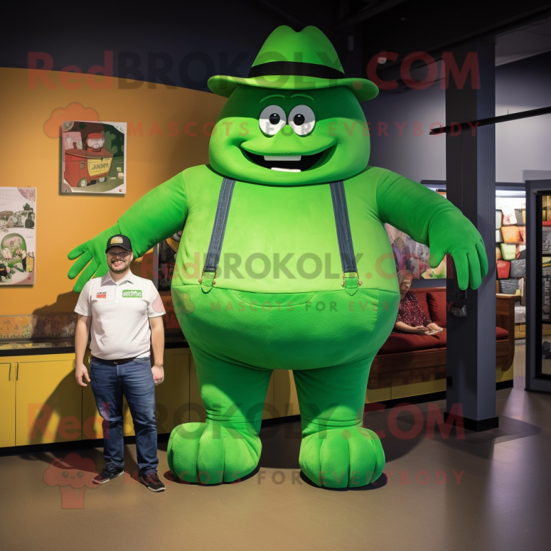 Green Strongman mascot costume character dressed with a Mom Jeans and Hat pins