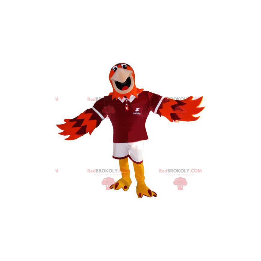 Oranžový a fialový maskot orla ve sportovním oblečení -