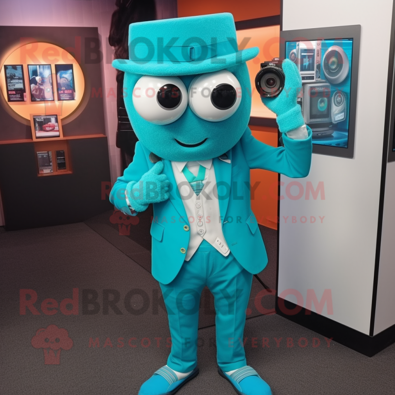 Turquoise Camera mascot costume character dressed with a Blazer and Digital watches