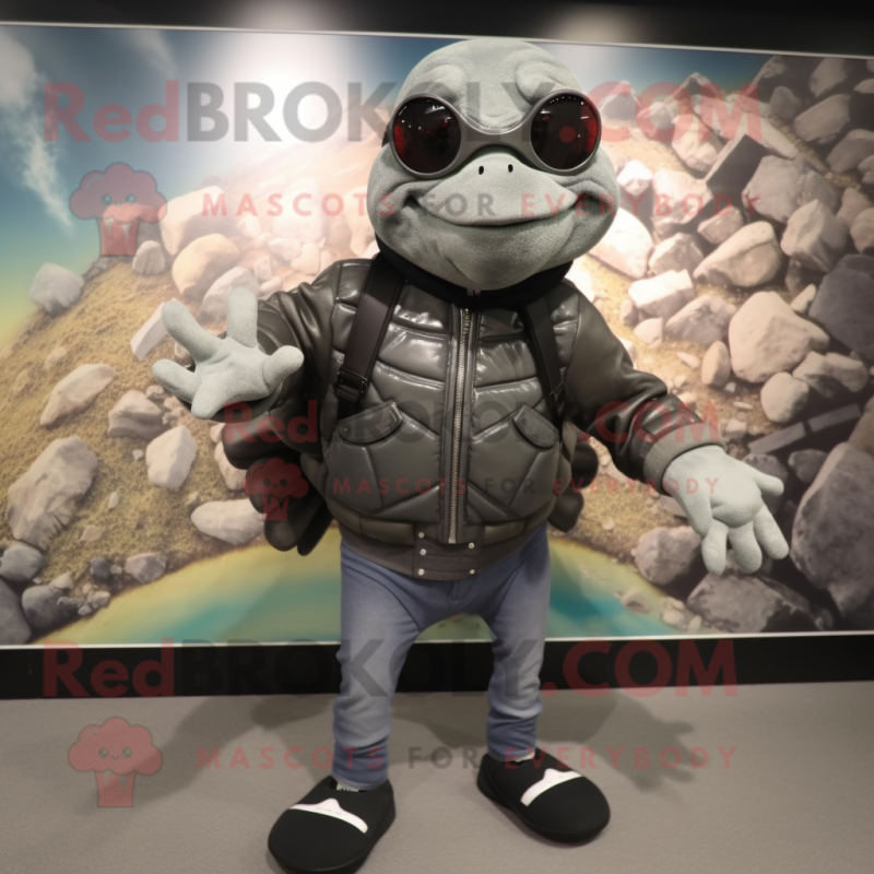 Gray Turtle mascot costume character dressed with a Biker Jacket and Backpacks