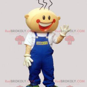 Lächelndes Jungenmaskottchen mit Overalls - Redbrokoly.com