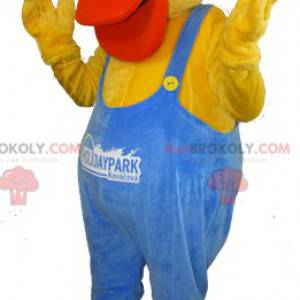 Yellow and orange duck mascot dressed in blue overalls -