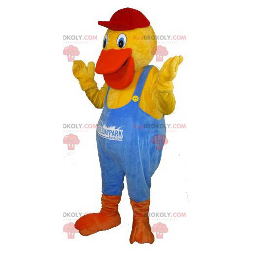 Mascote do pato amarelo e laranja vestido com macacão azul -