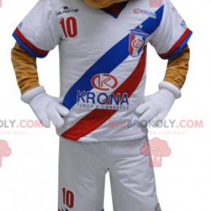 Mascote urso bege em roupas esportivas. Mascote ursinho de