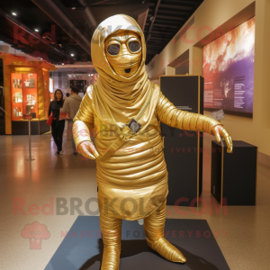 Gold Mummy mascot costume character dressed with a Hoodie and Messenger bags