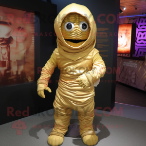 Gold Mummy mascot costume character dressed with a Hoodie and Messenger bags