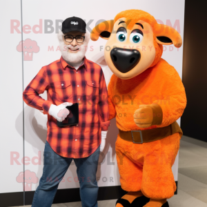 Orange Ram mascot costume character dressed with a Flannel Shirt and Smartwatches