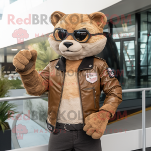 Cream Jaguarundi mascot costume character dressed with a Biker Jacket and Smartwatches