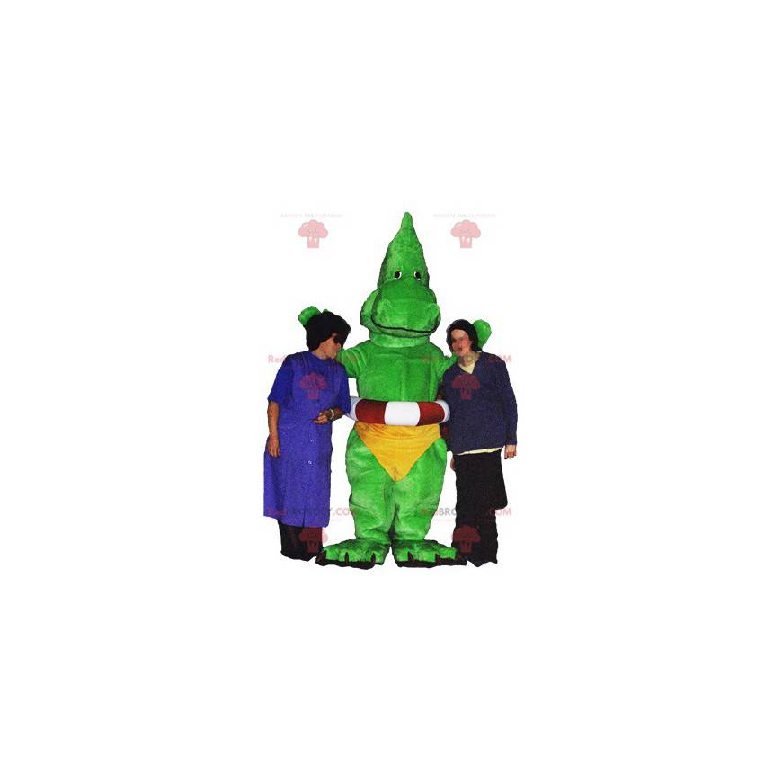 Mascota de dragón dinosaurio verde con calzoncillos amarillos -