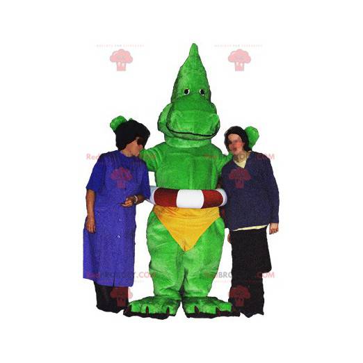 Green dinosaur dragon mascot with yellow underpants -