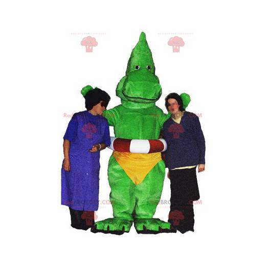 Mascotte drago dinosauro verde con mutande gialle -