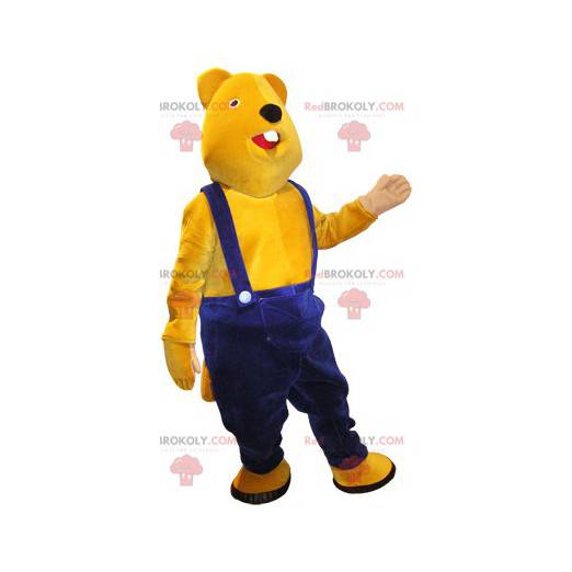 Mascote ursinho de pelúcia amarelo com macacão azul -