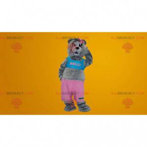 Šedý medvídek maskot oblečený v růžové a modré barvě -