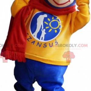 Mascotte de nounours bleu avec un pull jaune et une écharpe -