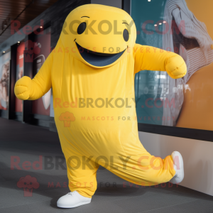 Yellow Humpback Whale mascot costume character dressed with a Joggers and Mittens