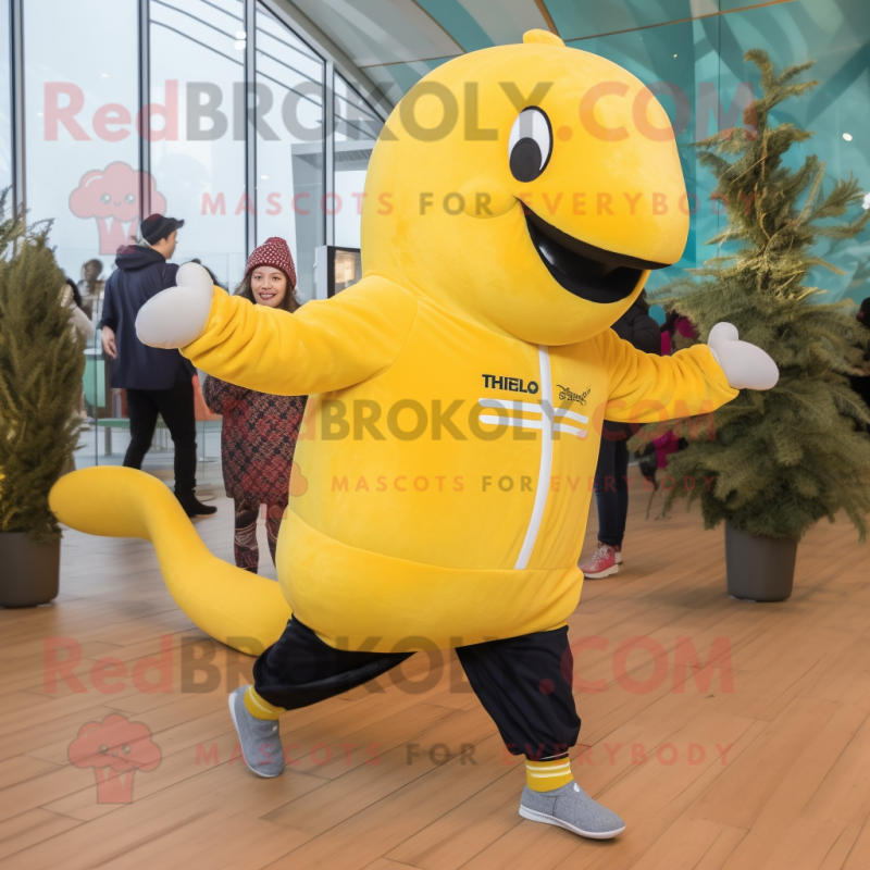 Yellow Humpback Whale mascot costume character dressed with a Joggers and Mittens