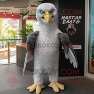 Silver Haast'S Eagle mascot costume character dressed with a Rash Guard and Tie pins