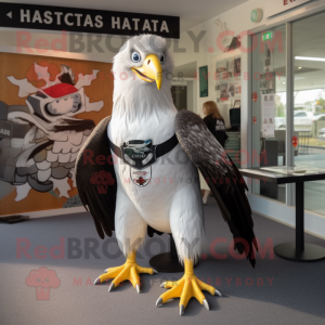 Silver Haast'S Eagle mascot costume character dressed with a Rash Guard and Tie pins