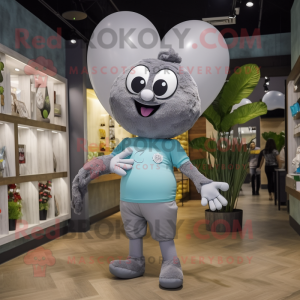 Gray Heart Shaped Balloons mascot costume character dressed with a Graphic Tee and Watches