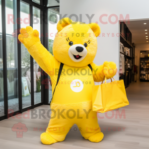 Lemon Yellow Bear mascot costume character dressed with a Jumpsuit and Tote bags