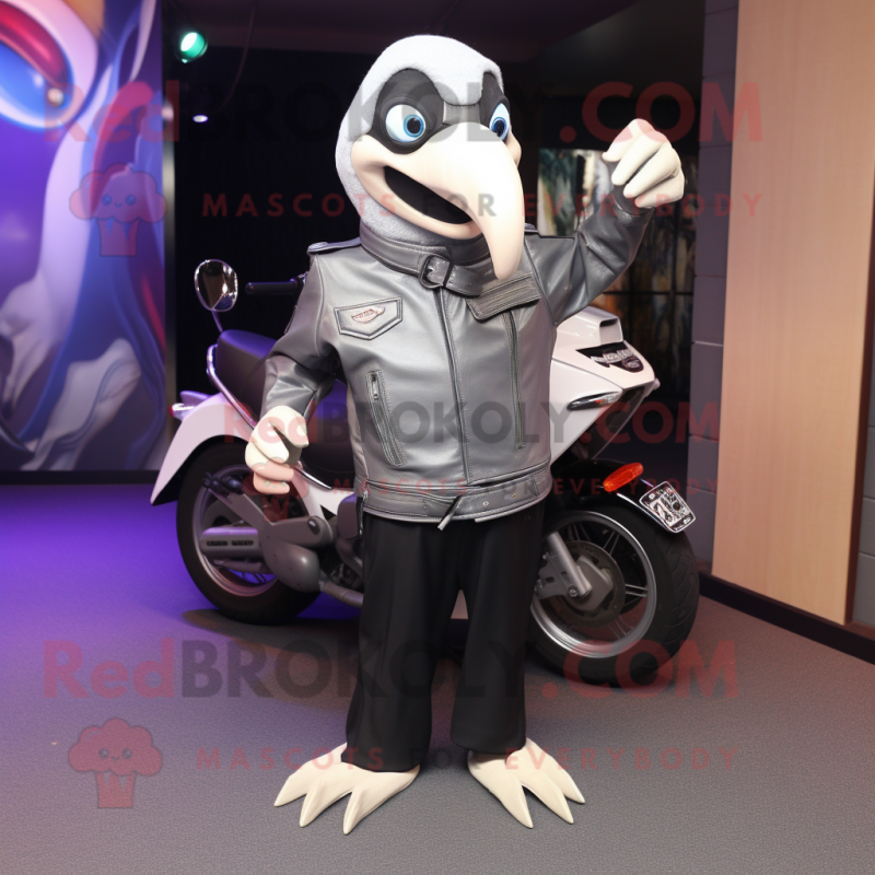 Silver Toucan mascot costume character dressed with a Biker Jacket and Messenger bags