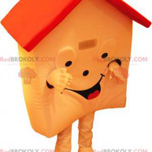 Mascote da casa laranja e vermelha muito sorridente -