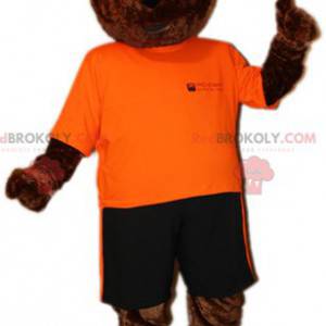 Maskotka niedźwiedź brunatny w pomarańczowo-czarnym stroju -
