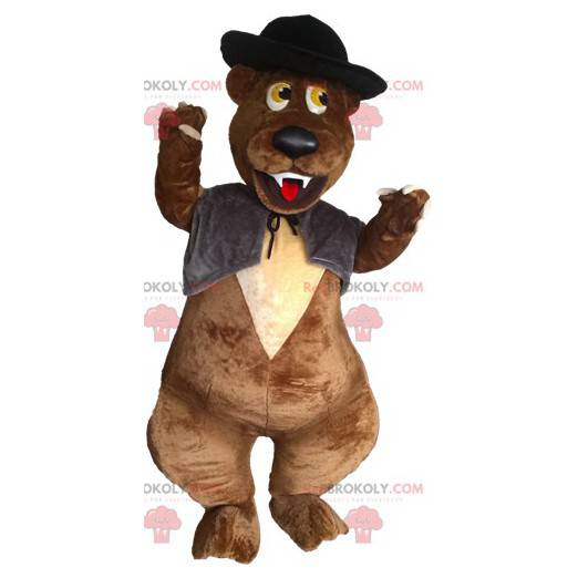 Mascotte d'ours marron avec un gilet et un chapeau -
