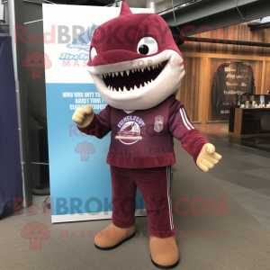 Maroon Shark mascot costume character dressed with a Rash Guard and Briefcases
