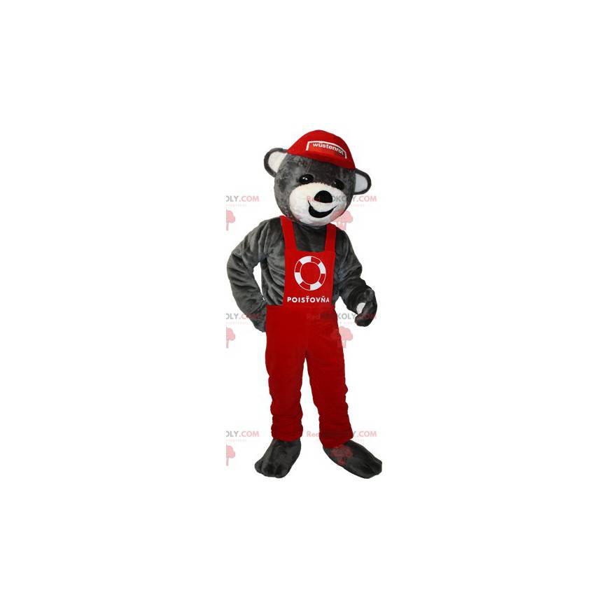 Graues Teddybär-Maskottchen in rotem Overall und Mütze -