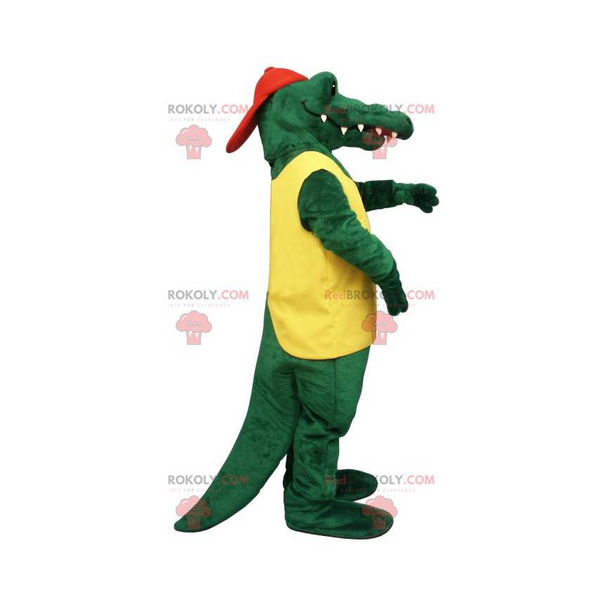 Mascote crocodilo verde em traje amarelo e vermelho -