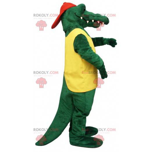 Mascota de cocodrilo verde en traje amarillo y rojo -