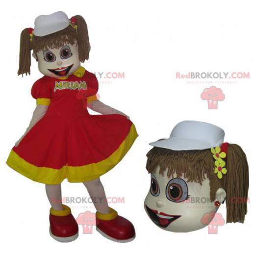 Mascote de menina em vestido vermelho e amarelo com colchas -