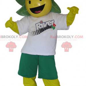 Mascotte de bonhomme jaune et vert avec des feuilles sur la