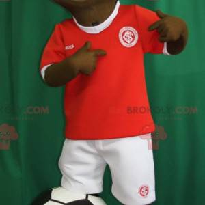 Jonge Afrikaanse jongensmascotte in voetballeruitrusting -