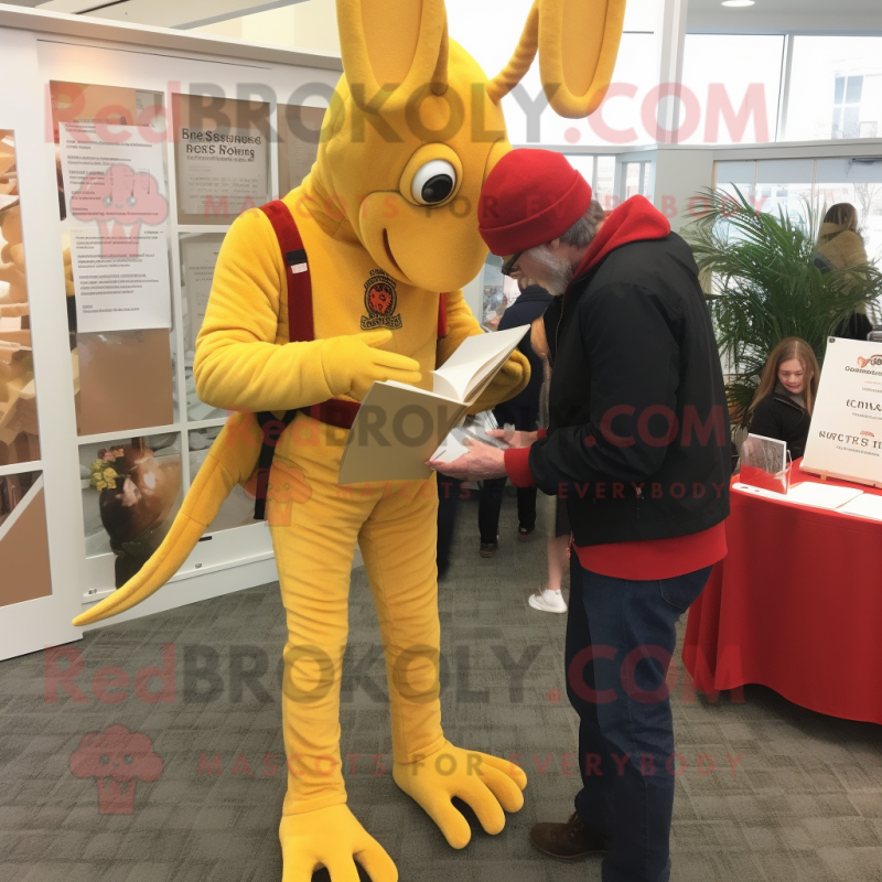 Gold Lobster Bisque mascot costume character dressed with a Corduroy Pants and Reading glasses