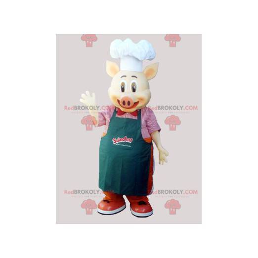 Lo chef mascotte di maiale cucina con un grembiule e un