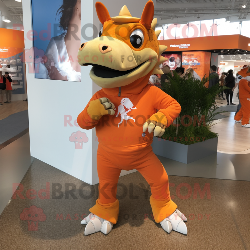 Orange Triceratops mascot costume character dressed with a Jeggings and Shoe laces Orange Triceratops mascot costume character dressed with a Jeggings and Shoe laces