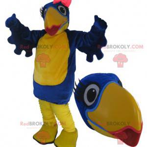 Mascotte de gros oiseau bleu et jaune avec du rouge à lèvres -