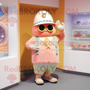 Peach Cyclops mascot costume character dressed with a Cardigan and Berets