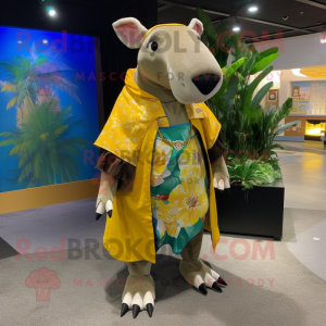 Gold Tapir mascot costume character dressed with a Bermuda Shorts and Shawls