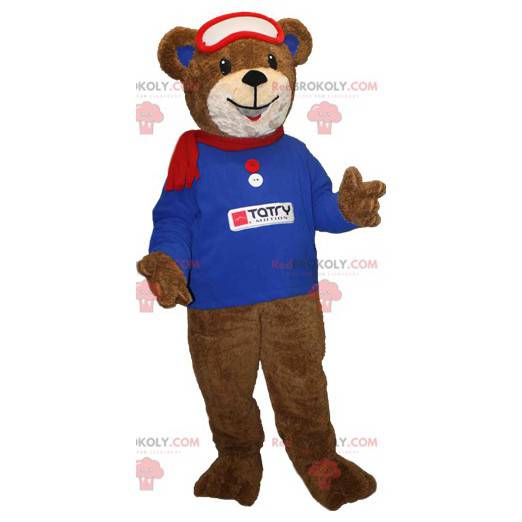 Mascotte orso bruno con una felpa blu e una sciarpa -