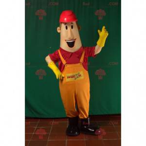 Mascot man in overalls with a construction helmet -