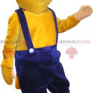 Maskottchen gelber Biber in blauen Overalls gekleidet -