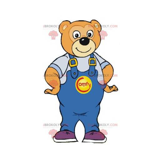 Mascotte d'ours marron souriant avec une salopette bleue -